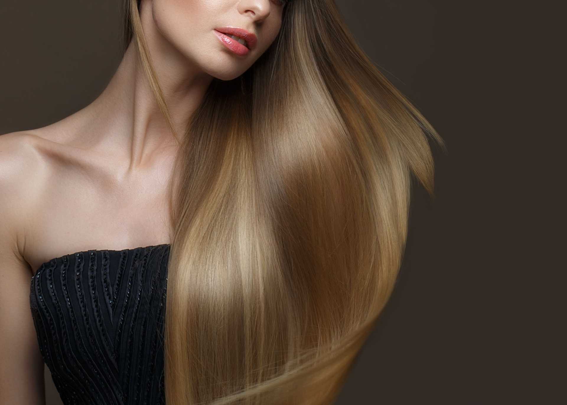 Long, smooth, flowing blonde hair showcased against a dark background.